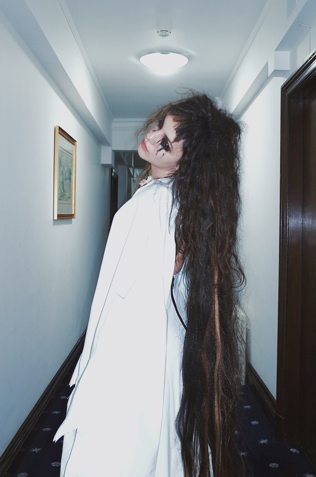 Among Others, figure alone in a narrow corridor