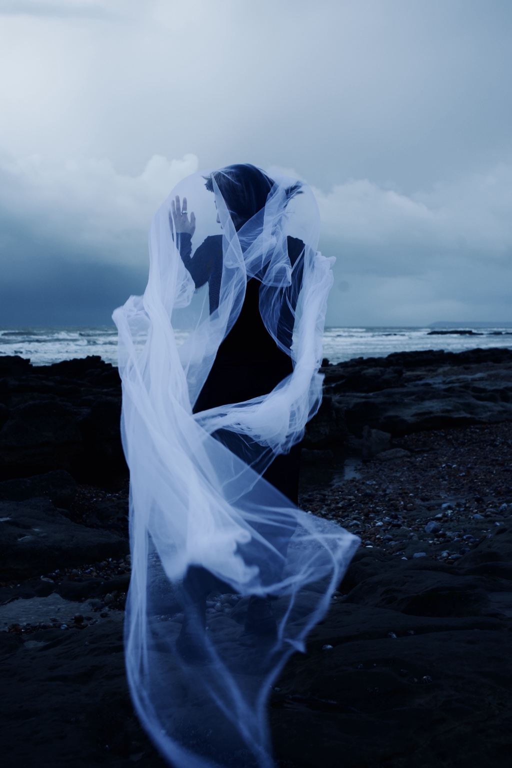 Dance with the Wind, hand visible behind a translucent layer of fabric