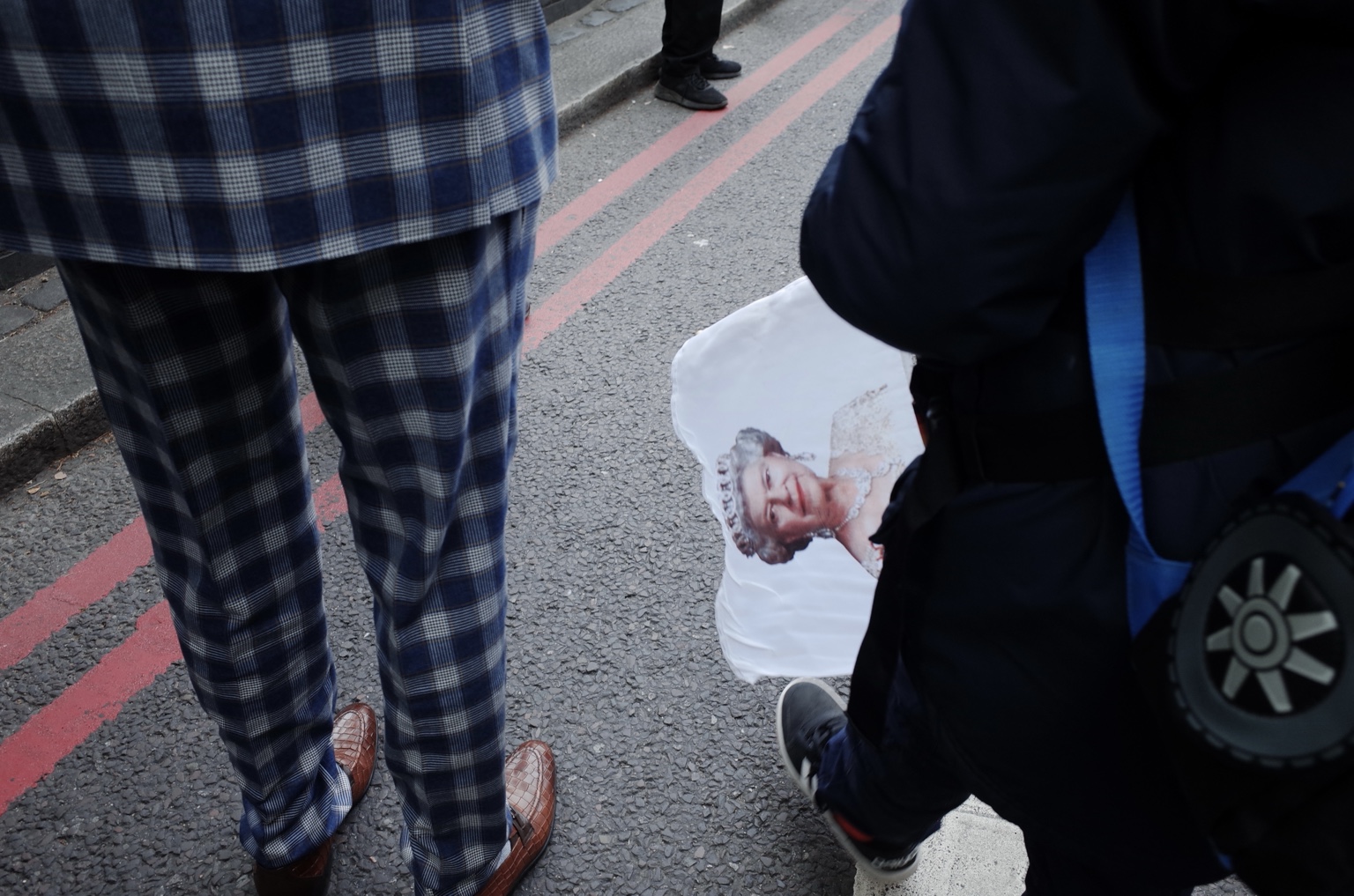 A printed portrait carried through the crowd in London, 19 September 2022