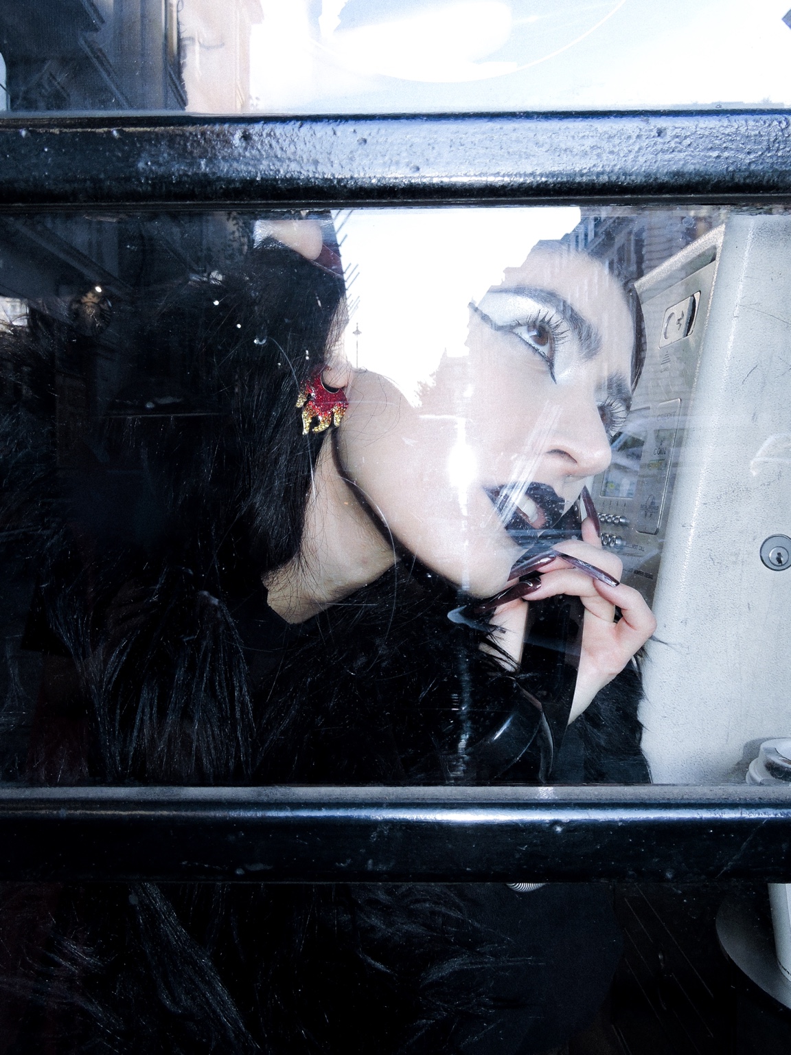 Portrait through a public telephone window, London, 26 October 2023
