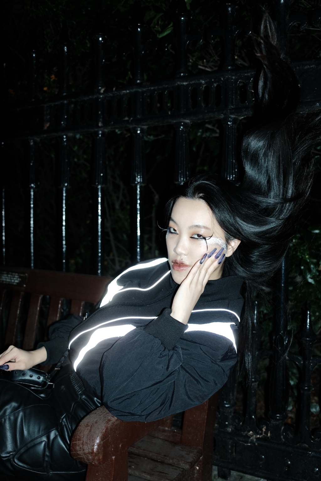 Seated figure with reflective garment and hair, London, 12 November 2023