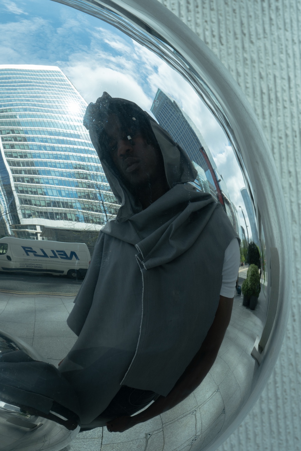 Dressed figure reflected in a convex mirror, London, 26 April 2024